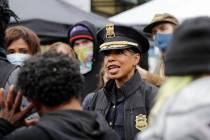 Seattle Police Chief Carmen Best talks with activists near a plywood-covered and closed Seattle ...