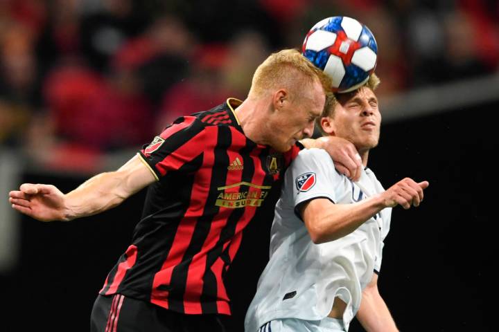 In this Oct. 19, 2019, file photo, Atlanta United defender Jeff Larentowicz, left, and New Engl ...