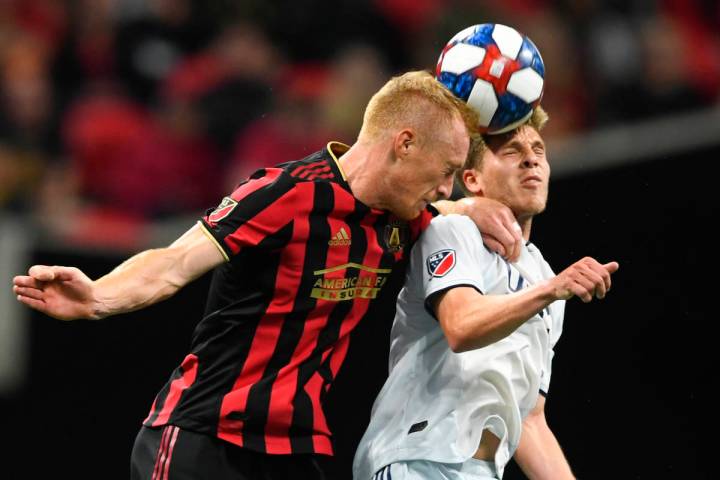 In this Oct. 19, 2019, file photo, Atlanta United defender Jeff Larentowicz, left, and New Engl ...