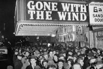 In this Dec. 19, 1939, file photo, a crowd gathers outside the Astor Theater on Broadway during ...