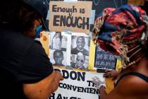 Wendy Long, left, and Sister Mamie, repost signs that were removed form the Lafayette Park para ...