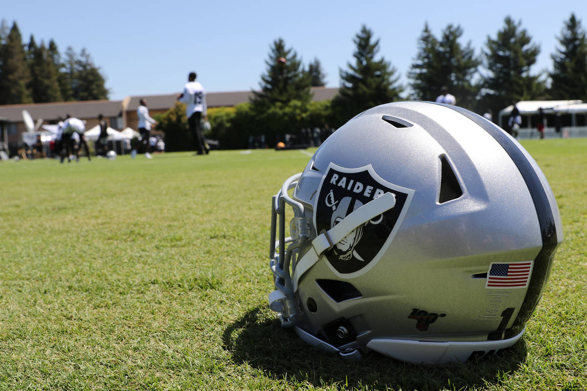 An Oakland Raiders helmet on the field during the NFL team's training camp in Napa, Calif., Sat ...