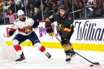 Golden Knights' Gage Quinney (72) sends the puck past Florida Panthers' Aaron Ekblad (5) during ...
