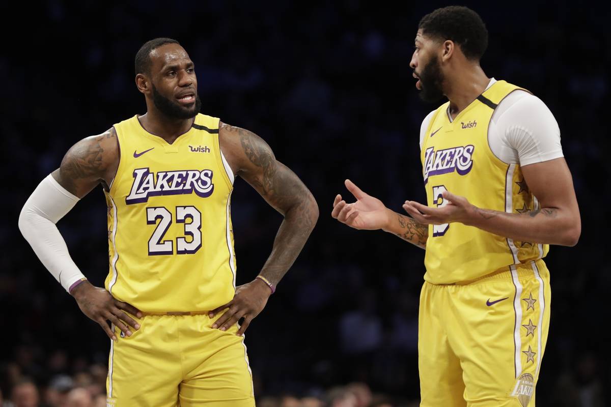 Los Angeles Lakers' LeBron James (23) talks to Anthony Davis (3) during the first half of an NB ...