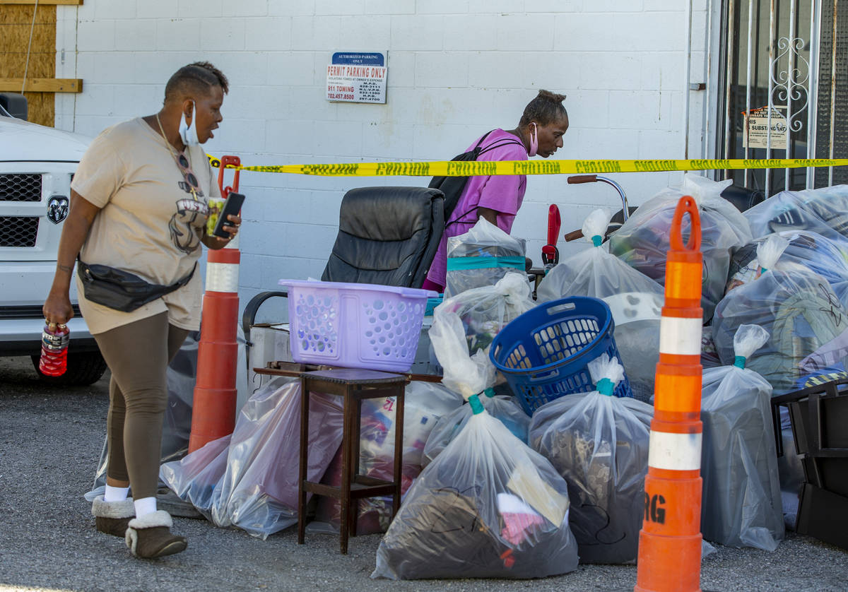 Former residents Audrey Palmer, left, and Helen Clark look through their possessions from their ...