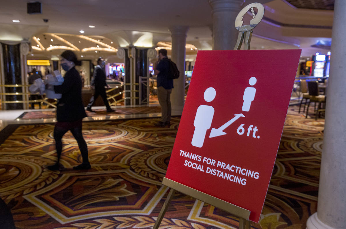 Social distancing signs are all about the lobby area for the re-opening procedures at Caesars P ...