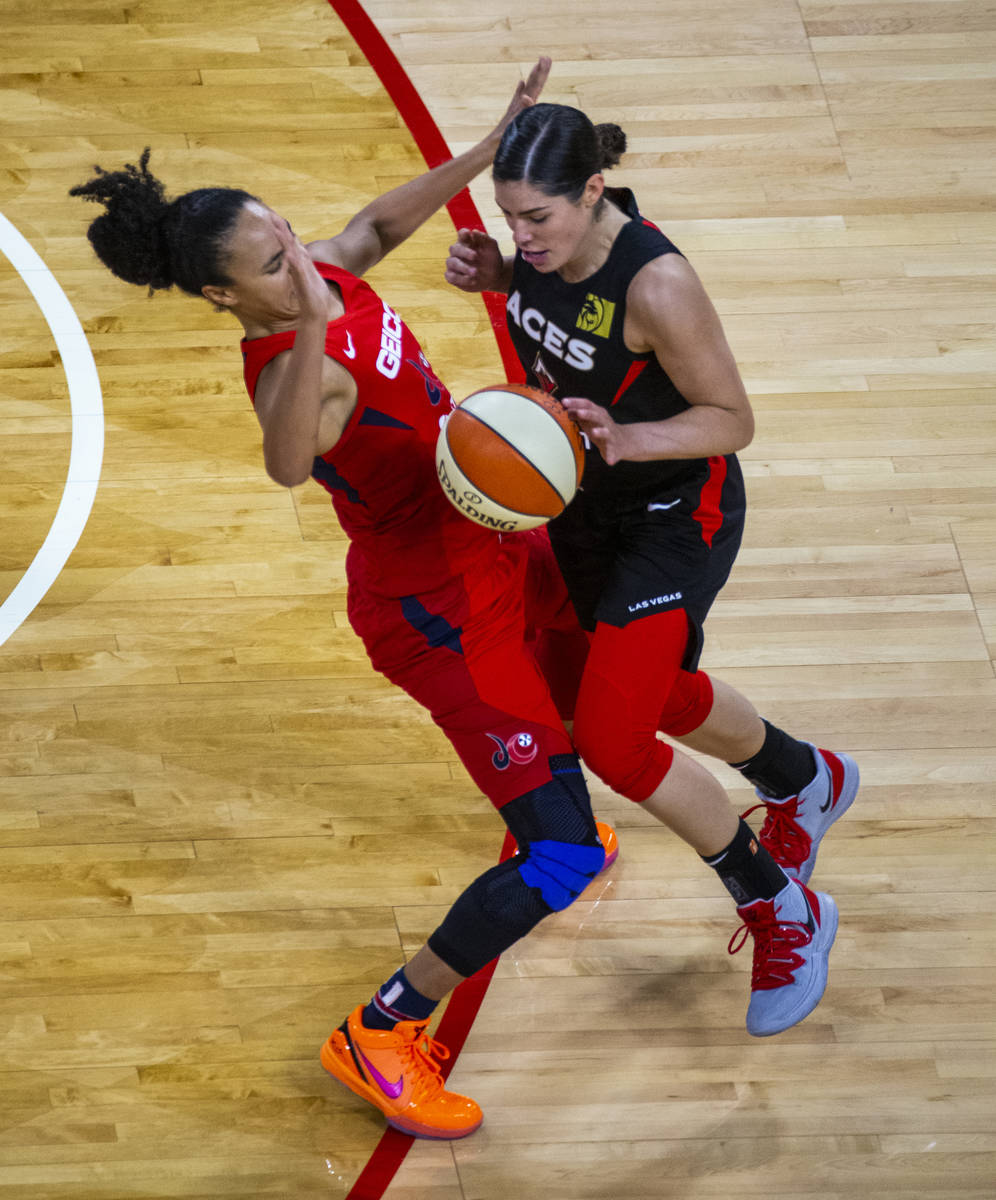 Washington Mystics guard Kristi Toliver (20, left) draws a critical charging foul late on Las V ...