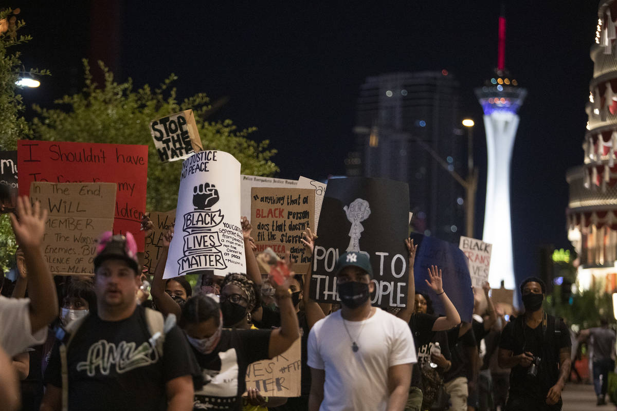 A protest against police brutality heads south on Las Vegas Boulevard, marching beside passing ...