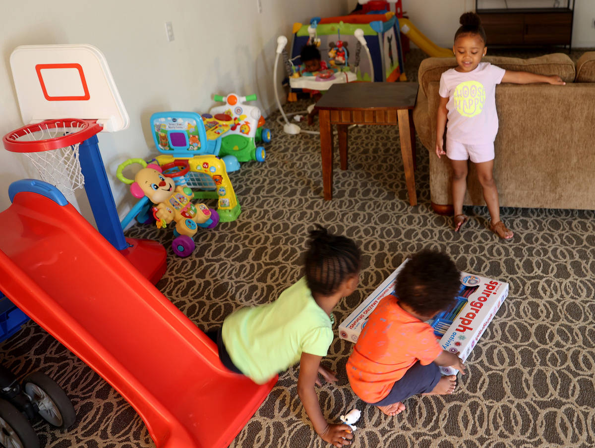 Some of Tytaliayah Parker's five unidentified foster siblings, facing away from camera, and her ...