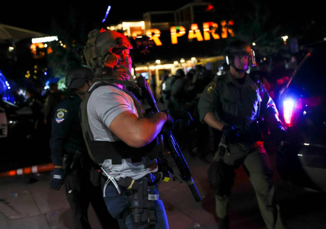 A man who appears to be impersonating a federal agent stands among Las Vegas police officers du ...