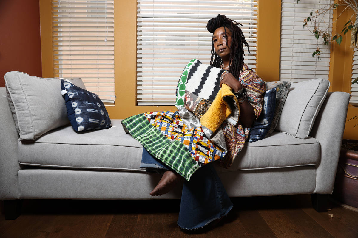 Erica Vital-Lazare, a college professor and artist, poses for a photo holding a quilt she made ...