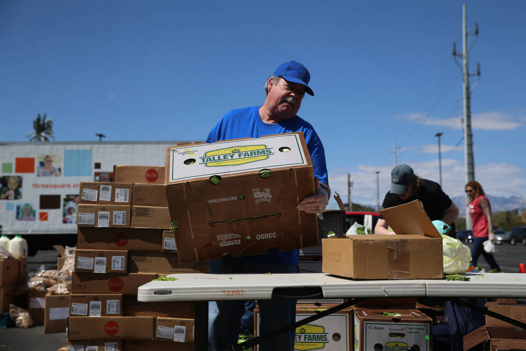 Three Square Food Bank volunteer John Castillo organizes food to give out at Palace Station Cas ...