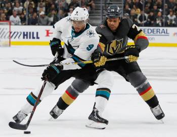 San Jose Sharks left wing Evander Kane (9) tries to skate around Vegas Golden Knights right win ...