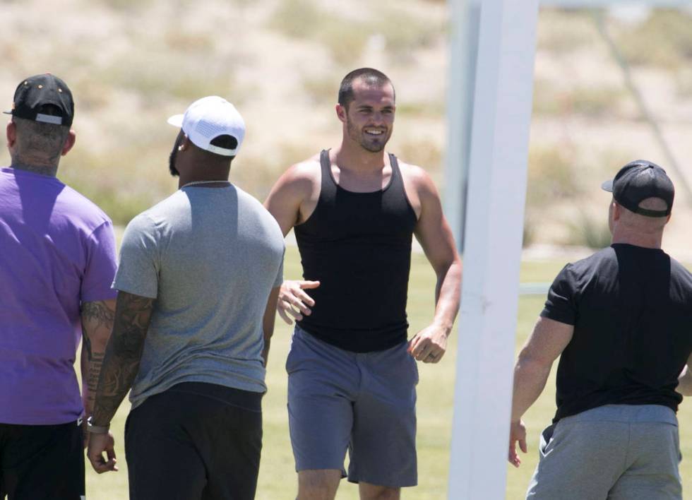 Las Vegas Raiders quarterback Derek Carr, second right, is seen after an unofficial practice on ...