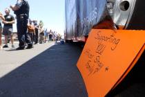 People wait in line to buy T-shirts during a fundraiser for Las Vegas police officer Shay Mikal ...