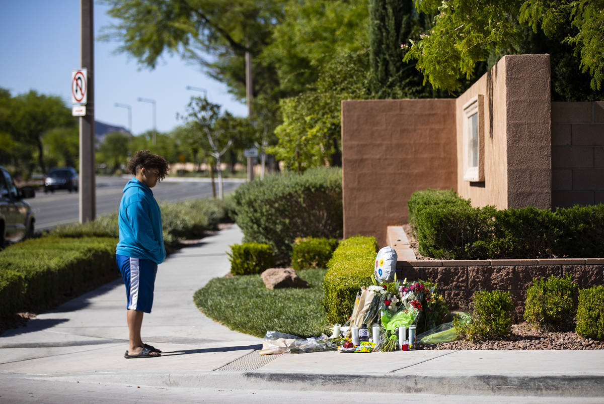 John Taylor, 14, visits the memorial left for David Cox, 18, and Brandon Cox, 14, brothers who ...