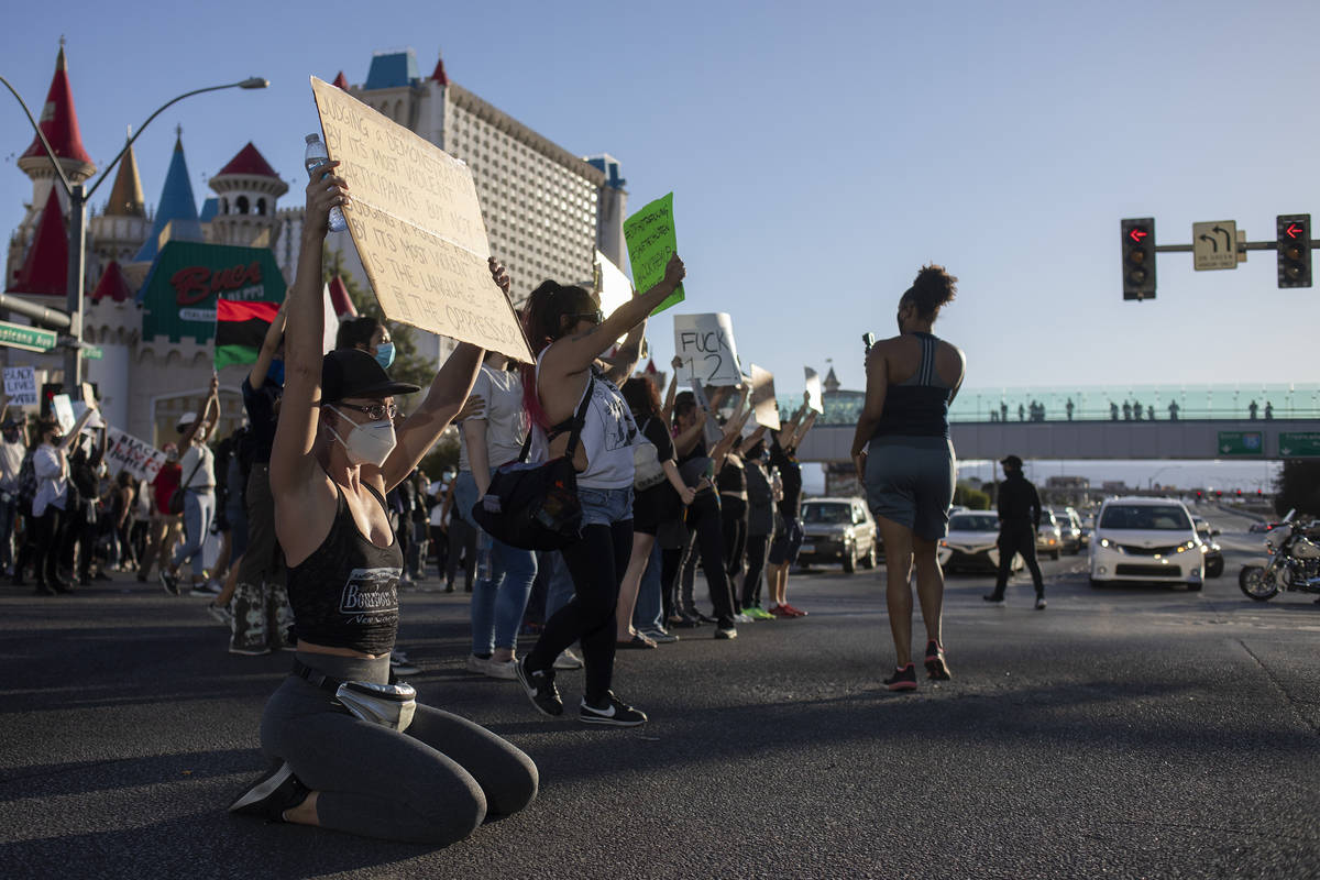 Protesters stop to show signs and chants to traffic at the intersection of Las Vegas Boulevard ...