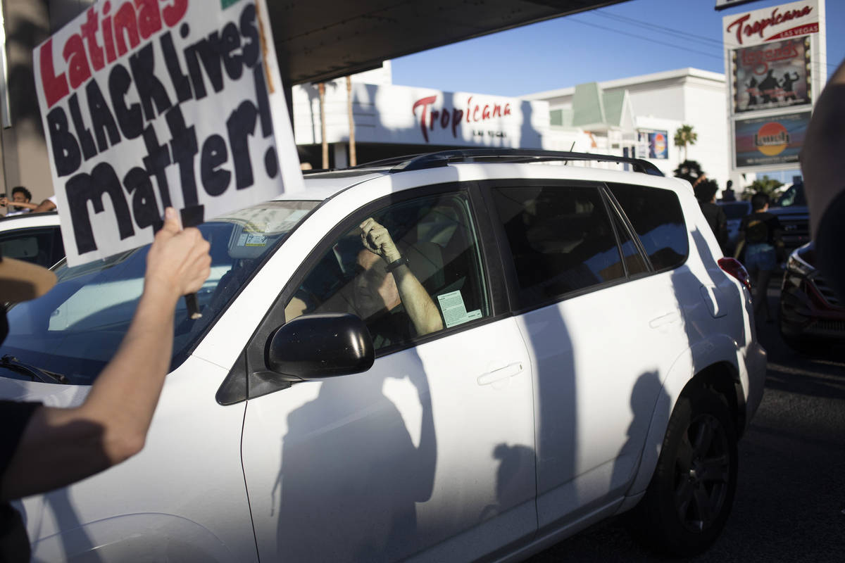 During a march against police brutality, protesters move into traffic driving north on Las Vega ...