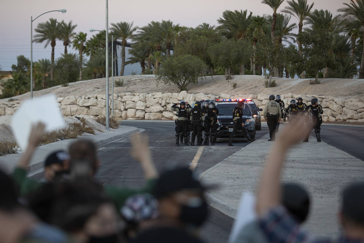Protesters, who marched against police brutality down Las Vegas Boulevard, are surrounded on tw ...