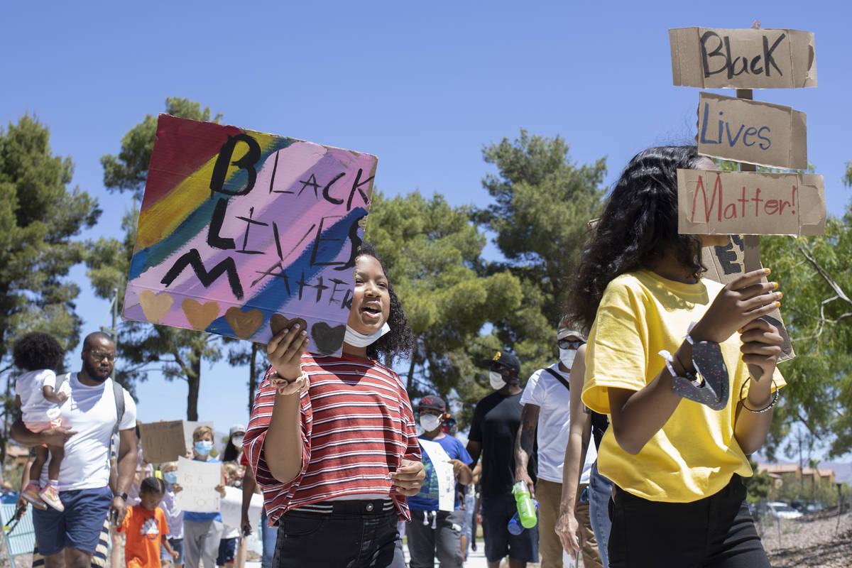 Ava Rose Turner, left, 8, and Kumei Tenorio-Norwood, right, 11, lead the "Kids Against Rac ...