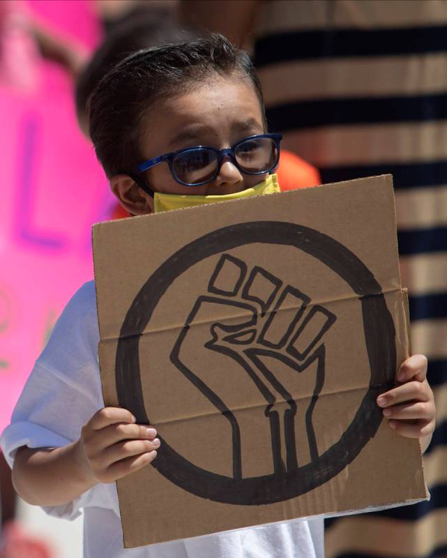Benjamin Sanchez, 6, marches in the "Kids Against Racism Rally" at Craig Ranch Region ...