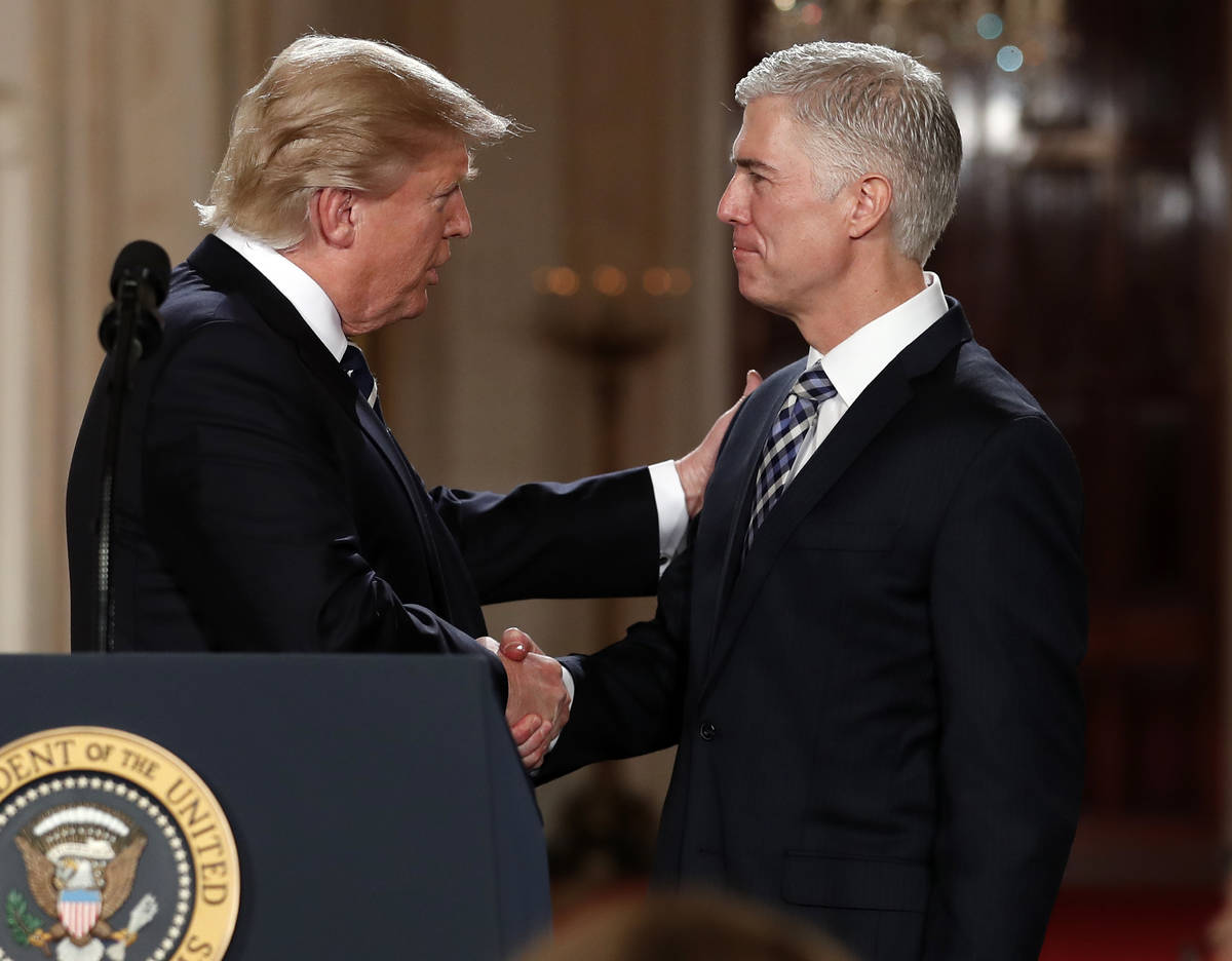 In this Jan. 31, 2017, file photo, President Donald Trump shakes hands with 10th U.S. Circuit C ...