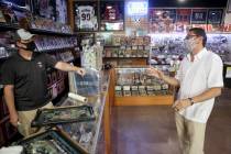 Jeremy Brown, owner of Ultimate Sports Cards and Memorabilia, talks to David Martinez of Delton ...