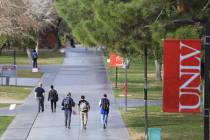 Students walk along a sidewalk at UNLV. (Review-Journal file photo)