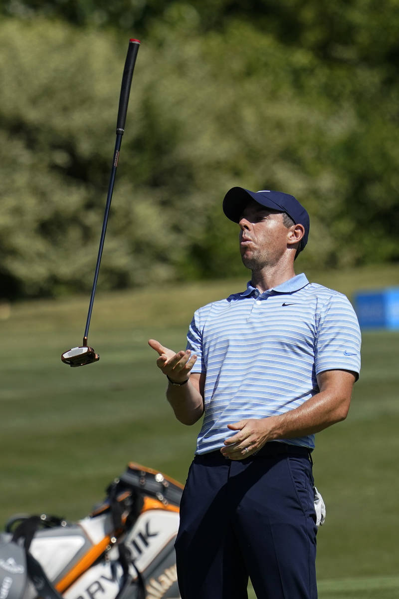 Rory McIlroy, of Northern Ireland, flips his putter after missing a birdie putt on the 15th gre ...