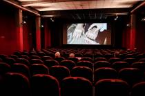 People sit in a cinema in Milan, Italy, Monday, June 15, 2020. Movie theaters are reopening acr ...