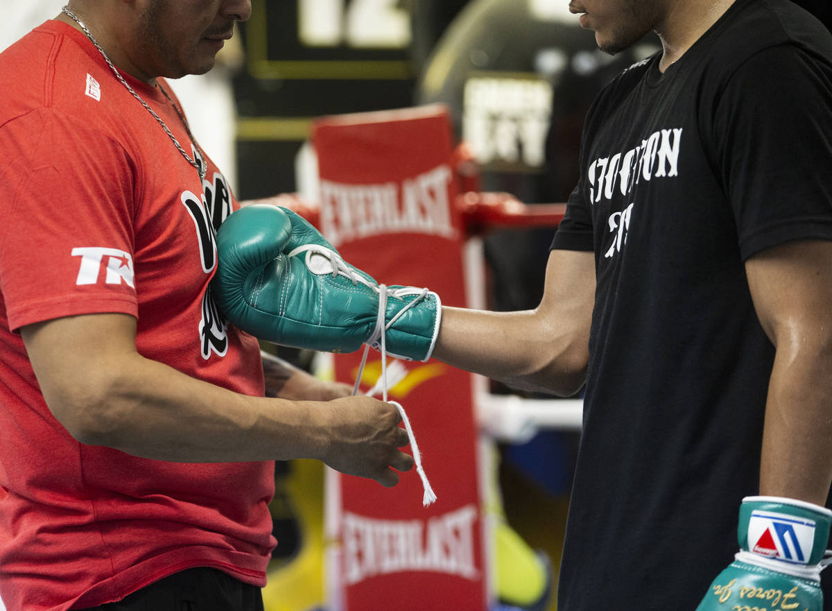 Gabe Flores Jr., right, prepares to work out with trainer and father Gabriel Flores Sr. at Cape ...