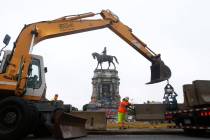 Workers for The Virginia Department of General Services install concrete barriers around the st ...