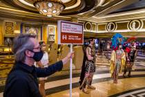 A social distancing sign helps to announce the royal court with Caesar and Cleopatra as part of ...