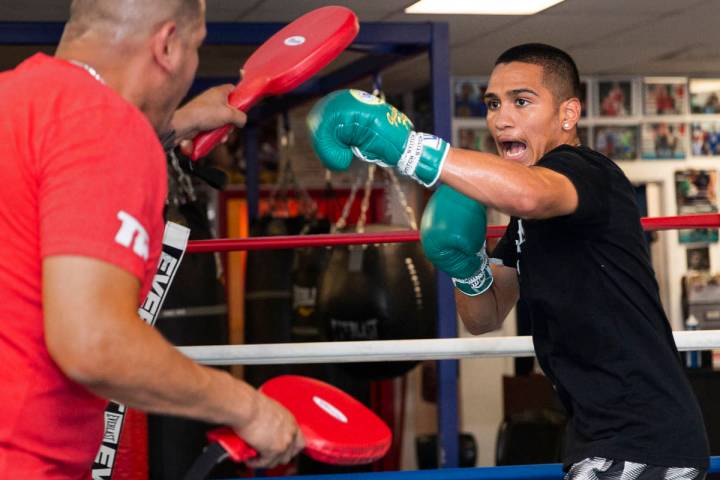 Gabe Flores Jr., right, works out with his trainer and father Gabriel Flores Sr. at Capetillo & ...