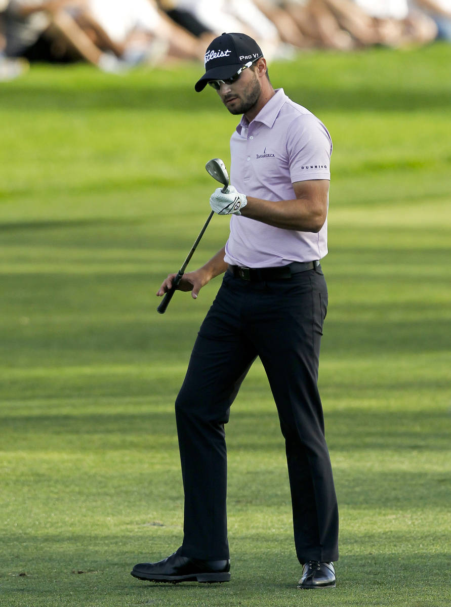Kyle Stanley looks at his wedge after hitting into the water on the 18th hole during final roun ...