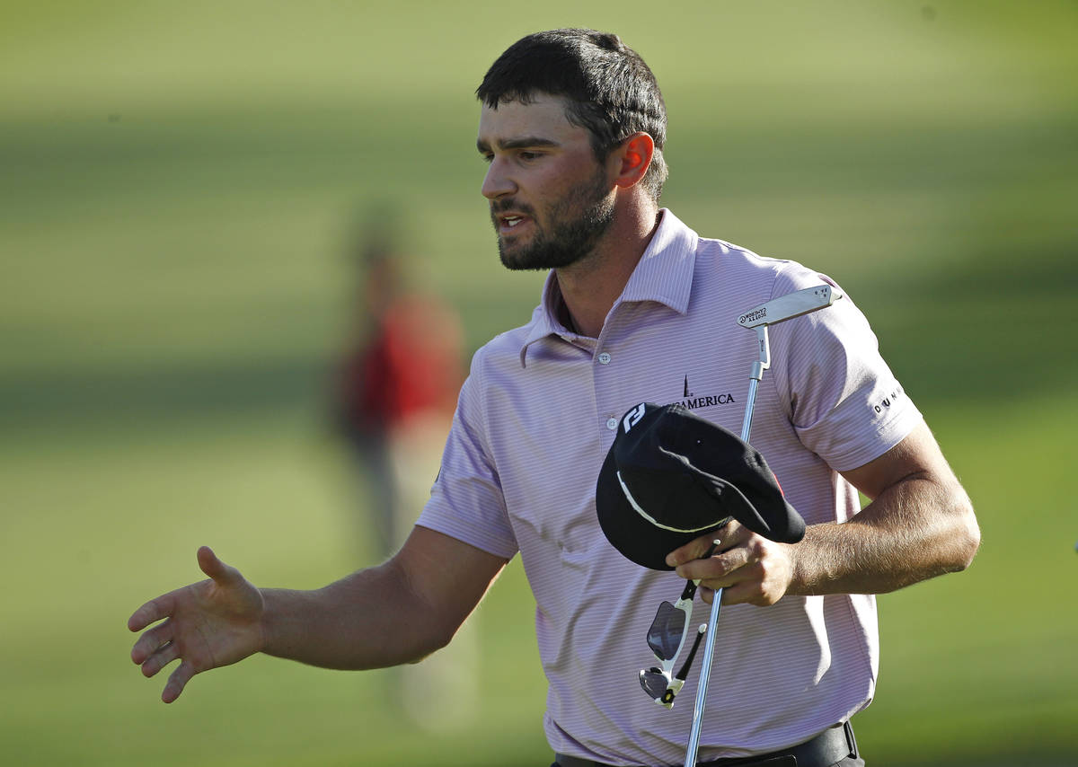 Kyle Stanley moves to shake hands with fellow competitors after making a triple bogey on the 18 ...