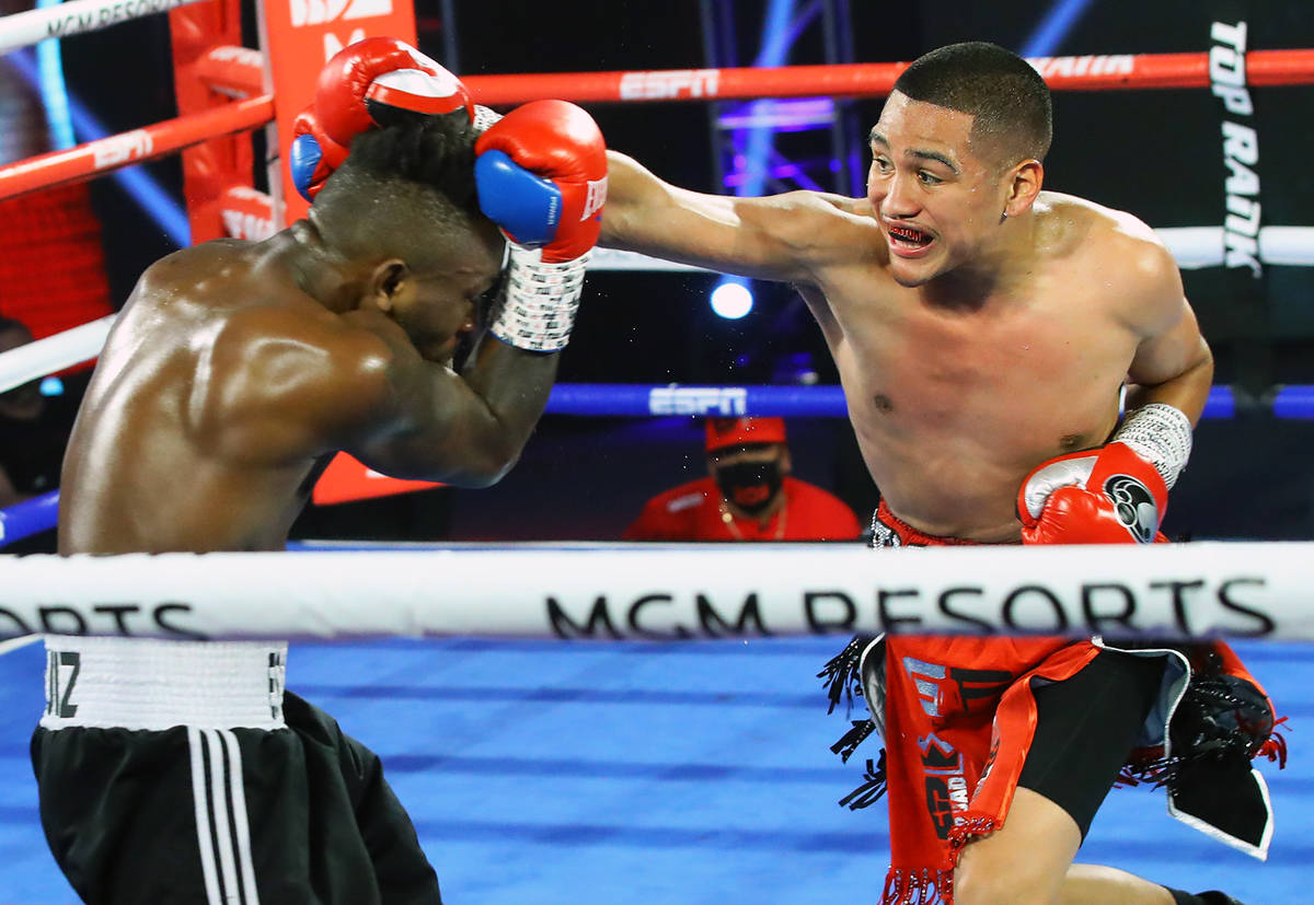 Gabriel Flores Jr., right, lands a punch against Josec Ruiz during their lightweight fight Thur ...