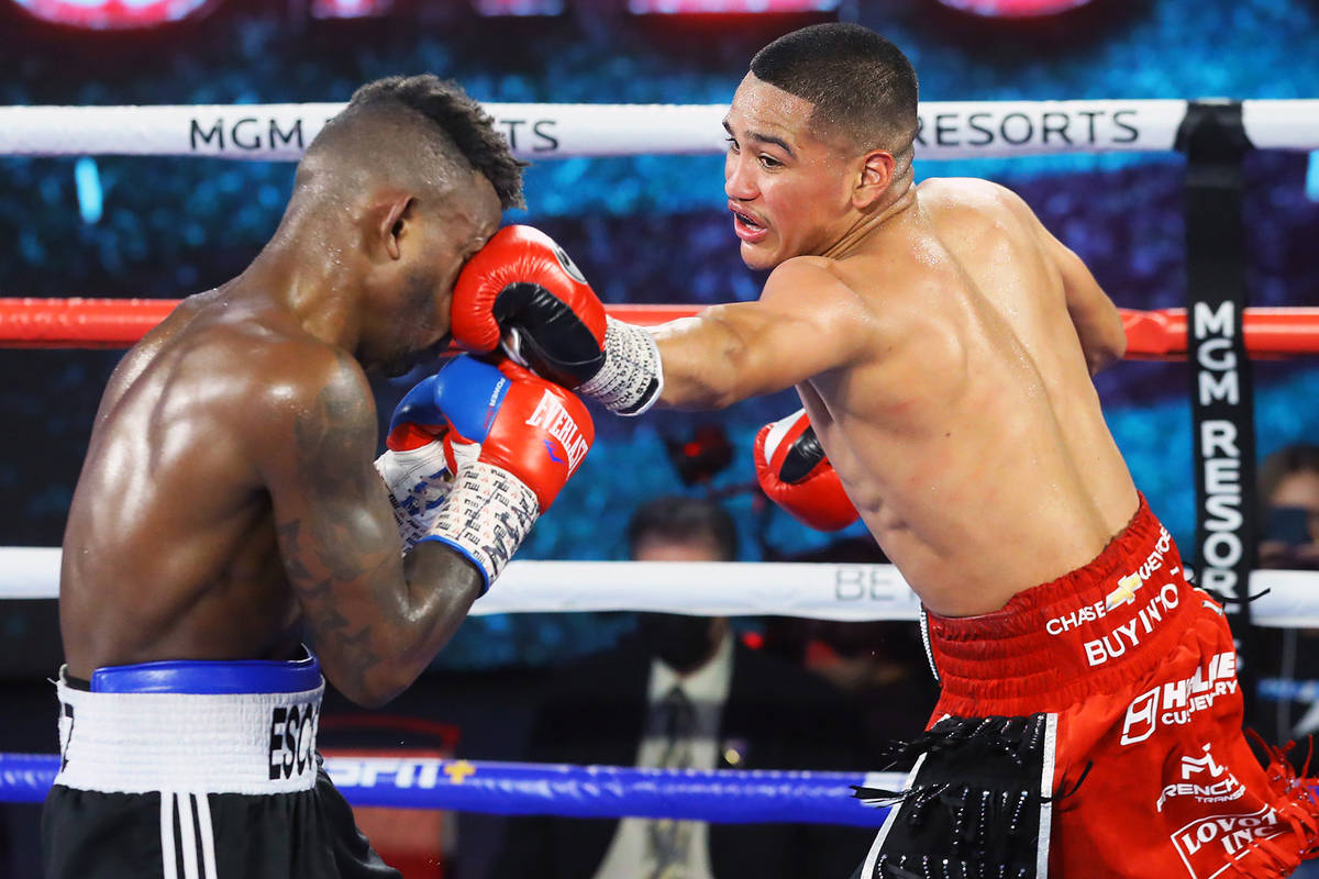 Gabriel Flores Jr., right, lands a punch against Josec Ruiz during their lightweight fight Thur ...
