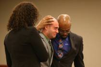 Former Las Vegas police Explorer Joshua Honea, center, reacts with his attorneys Monique McNeil ...