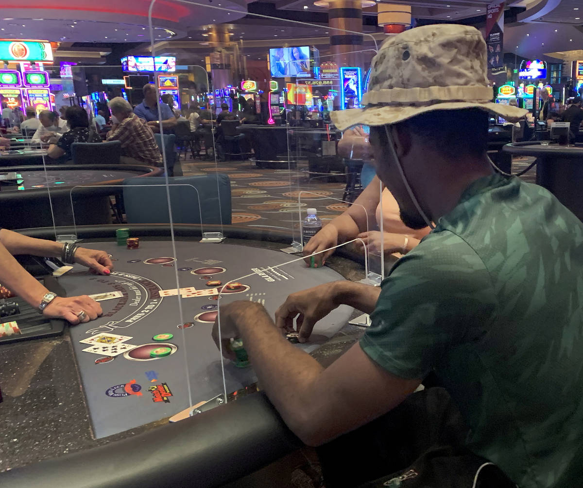 Individuals play table games at Gila River Casino at the Wild Horse Pass location on the packed ...