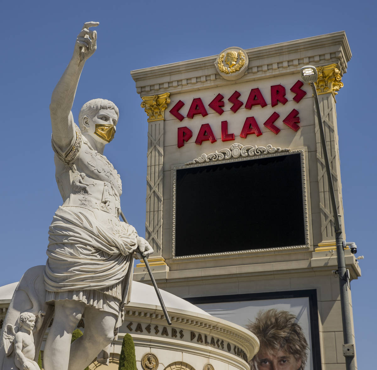 Caesar welcomes all out front while wearing a golden face mask following reopening ceremonies a ...