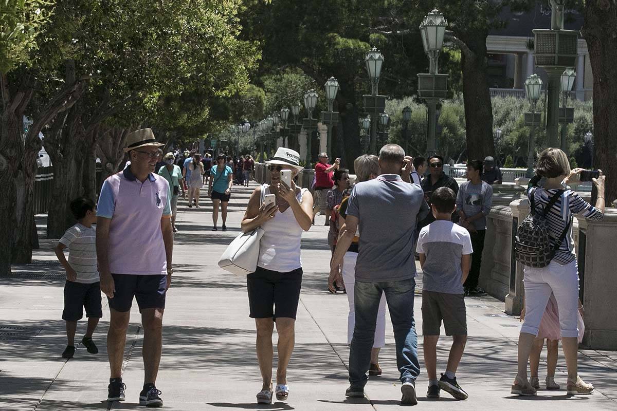 Tourists walk along Las Vegas Boulevard near the Bellagio fountains, June 7, 2020, in Las Vegas ...