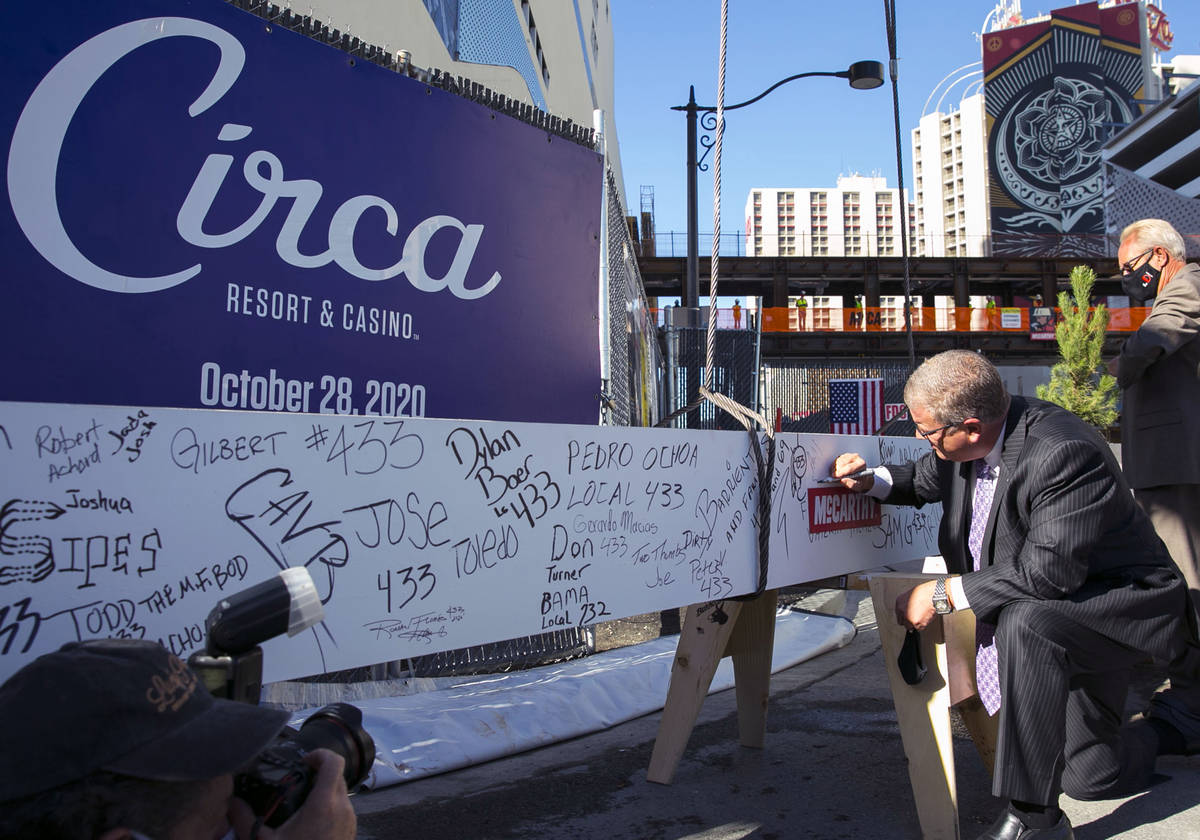 Derek Stevens, CEO and developer of Circa Resort and Casino, signs the last steel beam before i ...