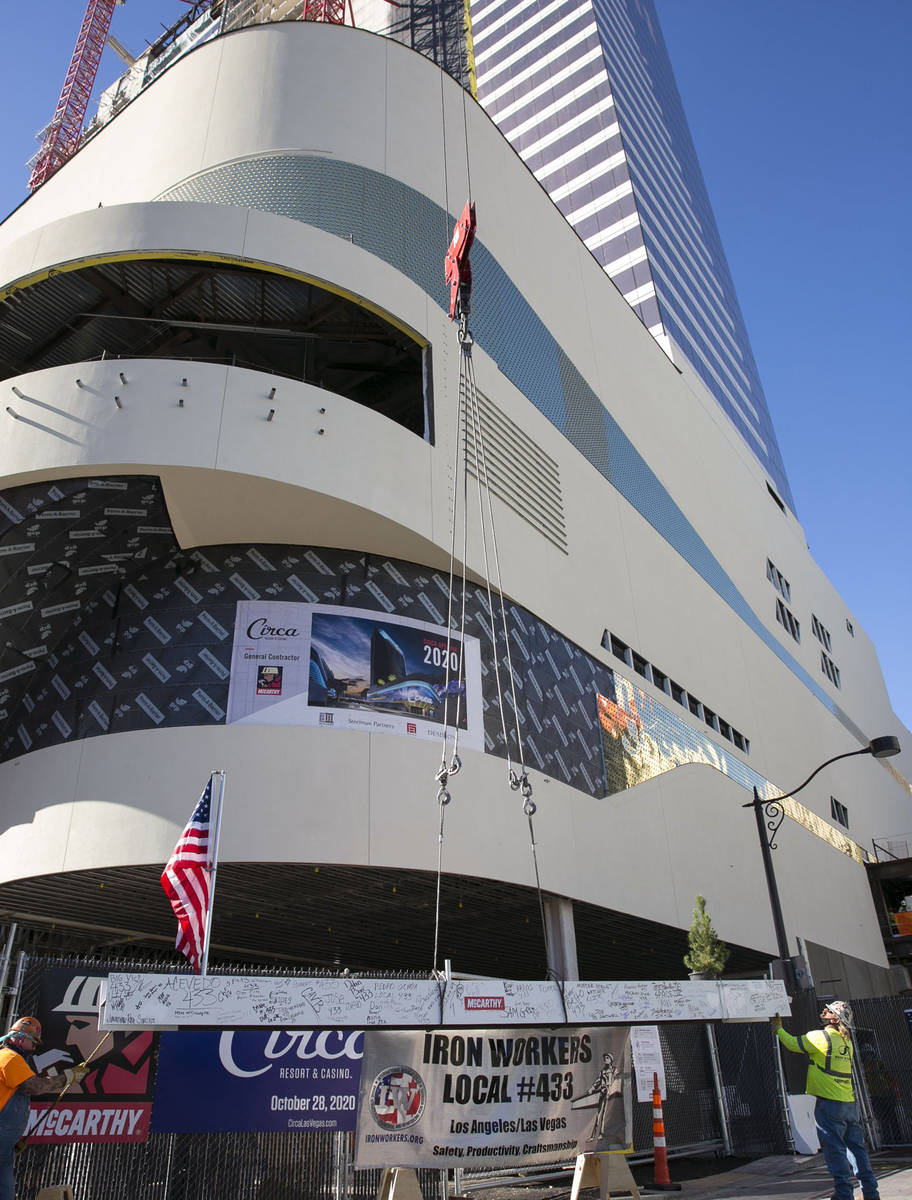 Workers hoist the last steel beam to place it on top of Circa's hotel tower on Friday, June 19, ...