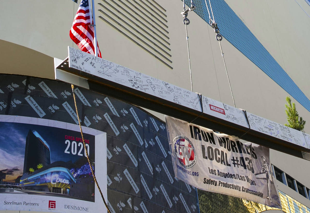 Workers hoist the last steel beam to place it on top of Circa's hotel tower on Friday, June 19 ...