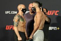 UFC featherweights Josh Emmett, left, faces off against Shane Burgos, right, as UFC president D ...