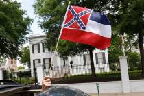 In this April 25, 2020 photograph, a small Mississippi state flag is held by a participant duri ...