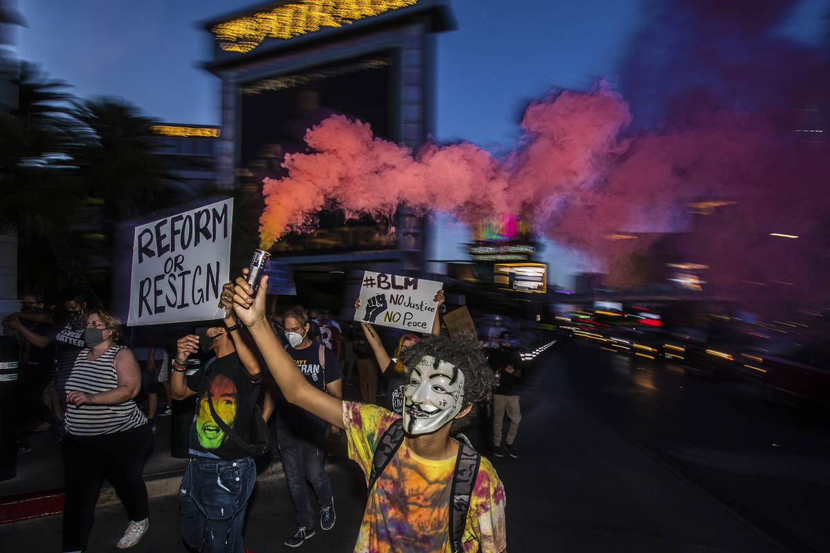 Protesters march south on the Strip during a Juneteenth rally organized by Black Lives Matter o ...