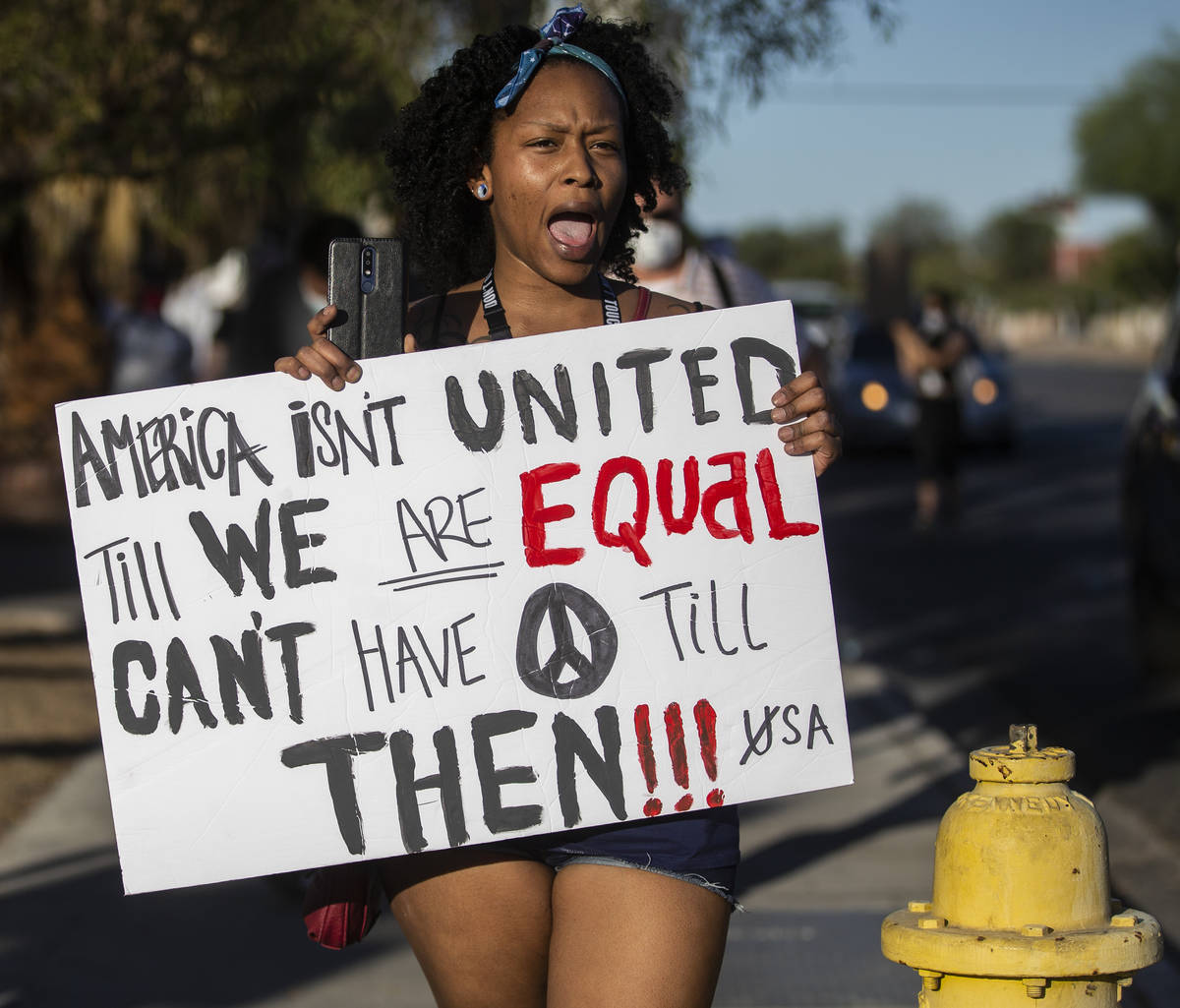 Protesters march west on Sahara Avenue during a Juneteenth rally organized by Black Lives Matte ...