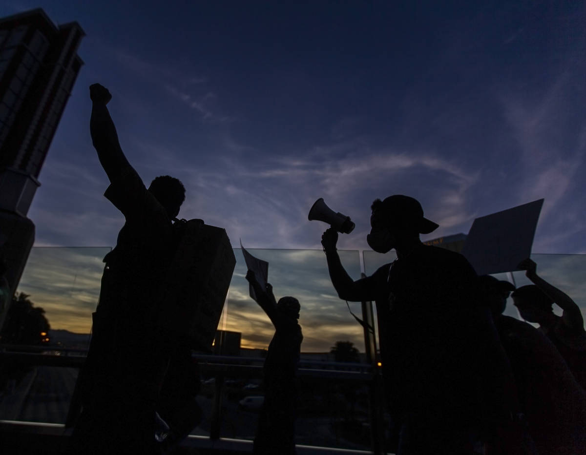 Protesters march south on the Strip during a Juneteenth rally organized by Black Lives Matter o ...